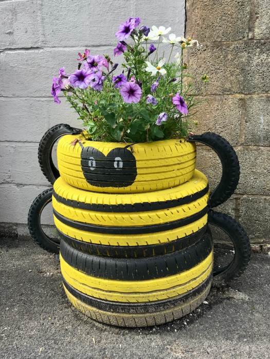 Bee tyre planter with petunias