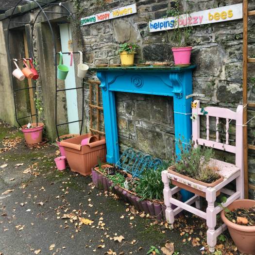 Alleyway garden with mantelpiece and chair planter