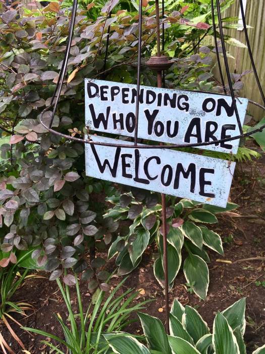 Sign saying 'Depending on who you are, welcome'