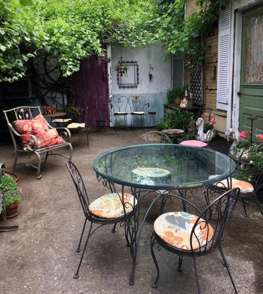 Mismatched metal chairs in a patio garden