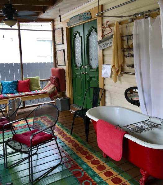 Red enamel bath with claw feet on a back porch in Memphis