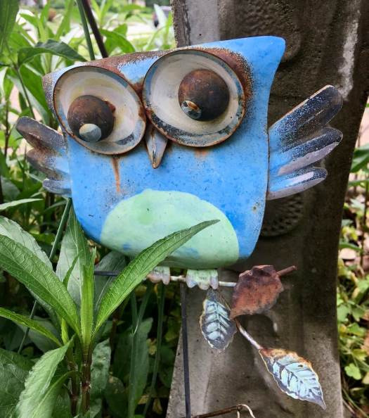 Yard art: metal owl on a branch