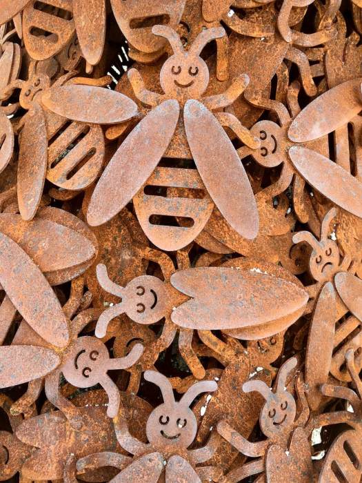 Beehold detail showing smiling and frowning bees