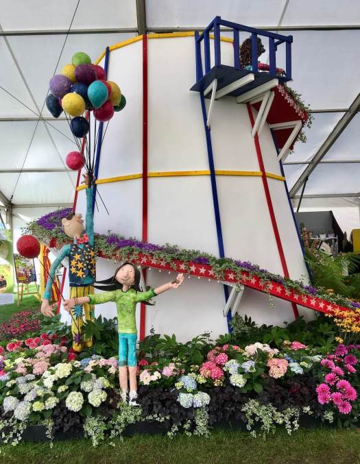 Helter skelter with flowers, children and balloons