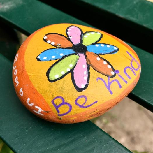Pebble decorated with a flower and Be Kind
