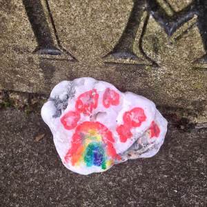 Rock decorated with rainbow and hearts by a child