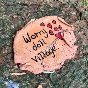 Worry doll village sign with hearts