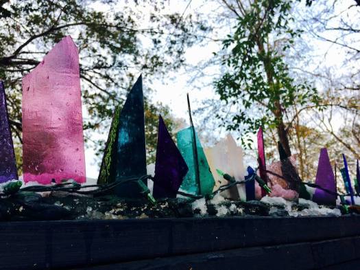 Shards of coloured glass on a fence