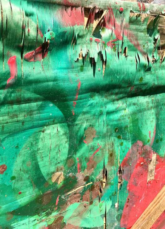 Green and red panel with peeling paint