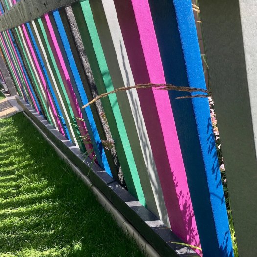 Blue, grey, green and pink fence at RHS Hampton Court Flower Show
