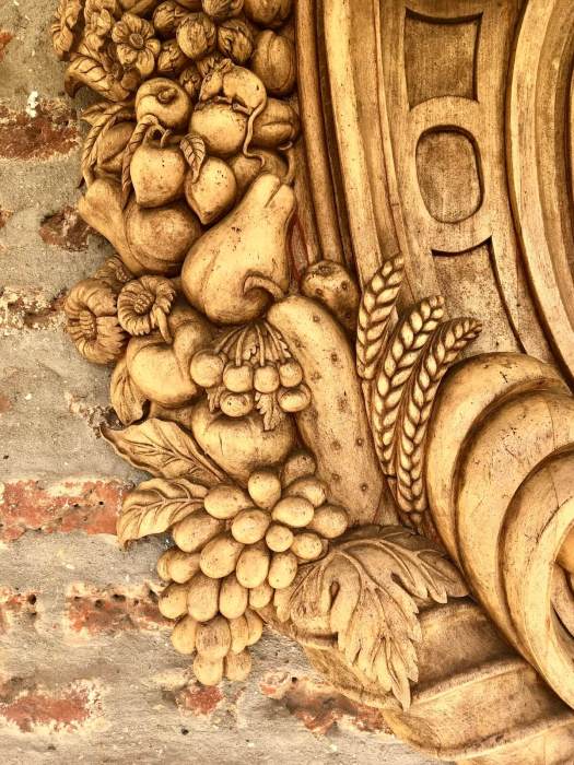 Harvest carving with a mouse on a wooden plaque at Hampton Court Palace