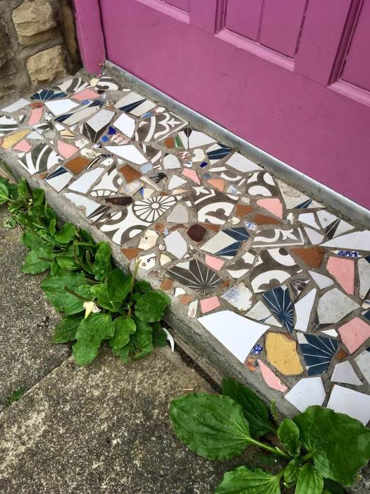 Mosaic doorstep with pink door in Hebden Bridge
