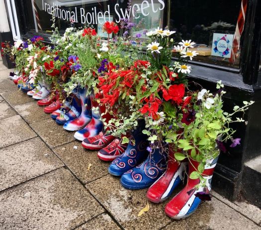 Wellies with flowers outside a sweet shop in Knutsford