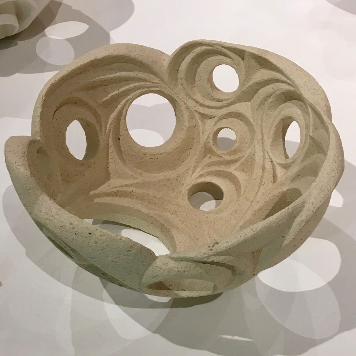 Spot lighting adds decorative shadows to a geometric bowl by Hamila Cassell