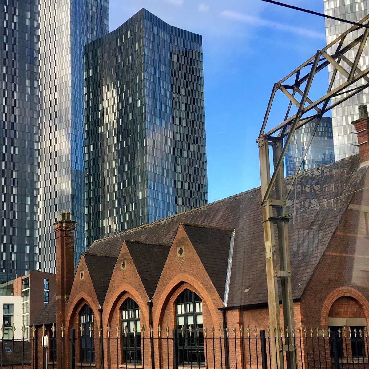 Modern tower blocks with a traditional building in Manchester