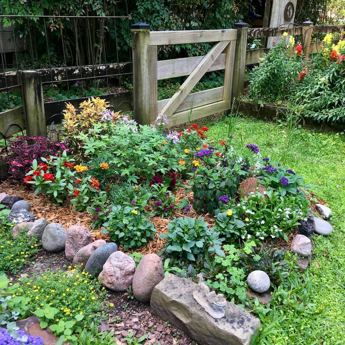 Flower bed edged with stones of various shapes and colours