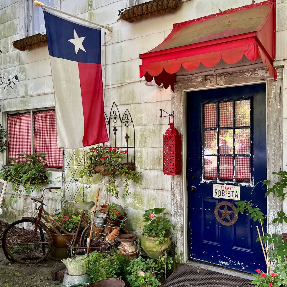 Cottage with a Texas flag and car tag