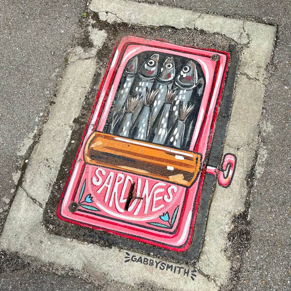 Manhole cover painted like an open tin of sardines by Gabby Smith in Hattiesburg Pocket Museum, MS