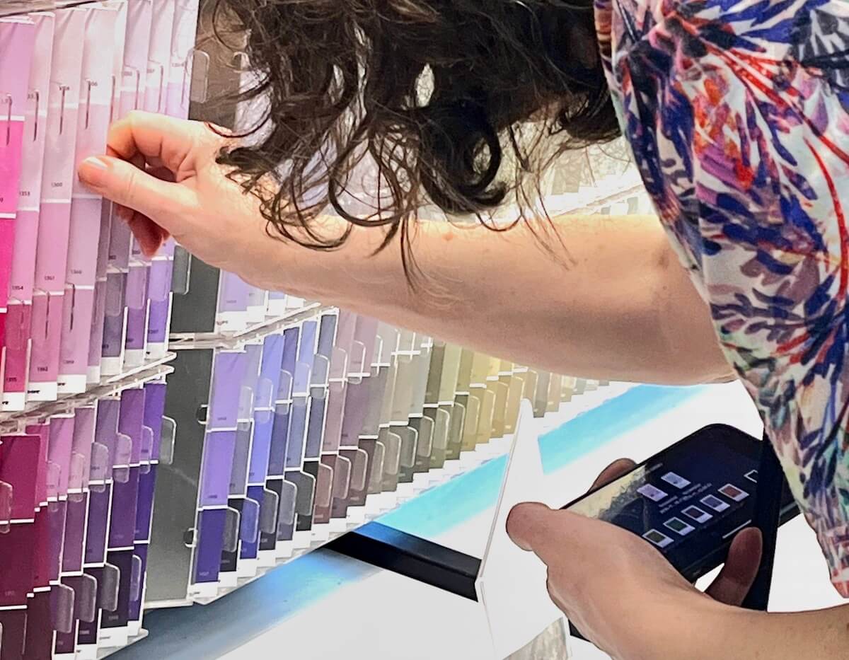Picking out colours in a paint store to match ones screen-shotted on an iPhone
